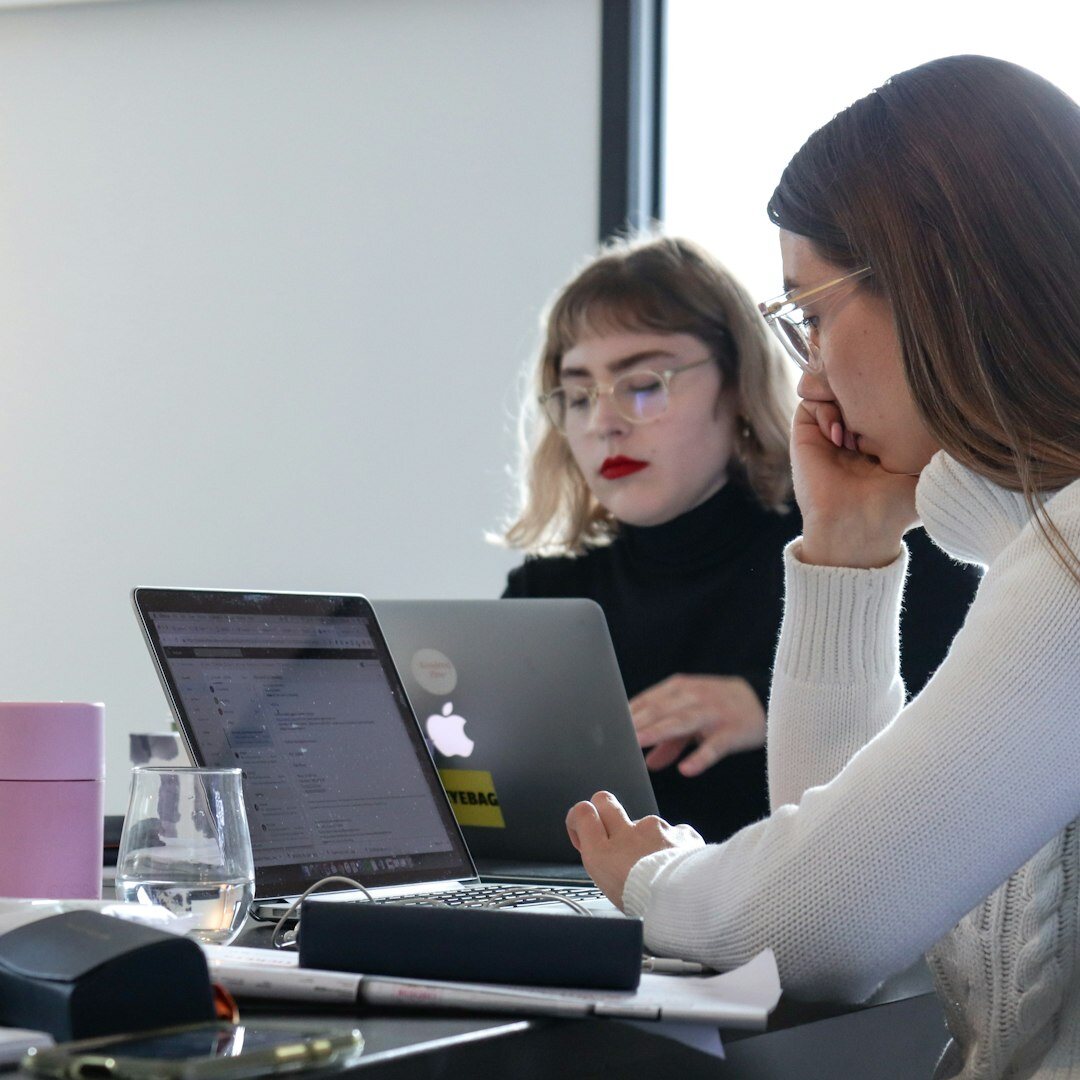 Two colleagues having a friendly conversation in an office